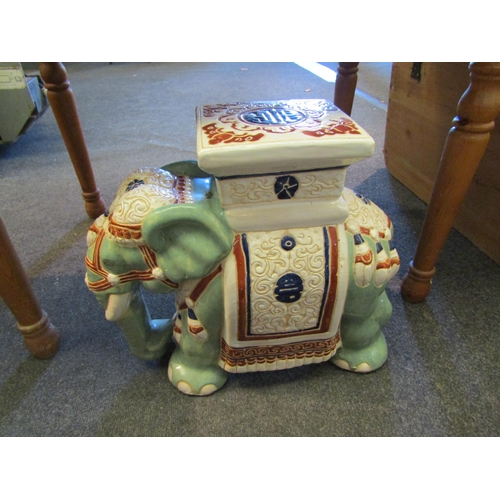 1107 - A modern Chinese style glazed pottery jardiniere stand in the form of an elephant, 45cm high