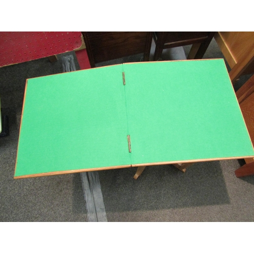 1114 - A 1940’s light oak compact card table with baize lining