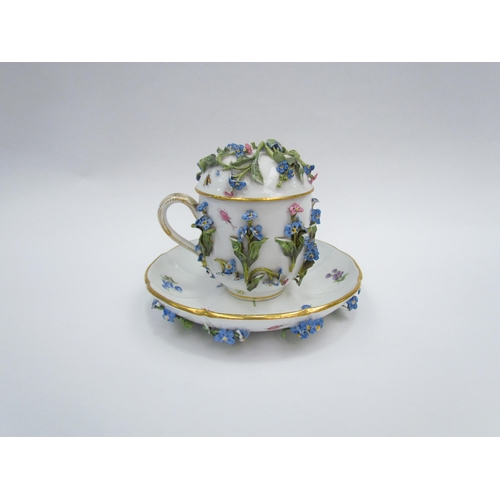 1297 - A 19th Century Meissen chocolate cup and cover decorated with high relief flowers and painted insect... 