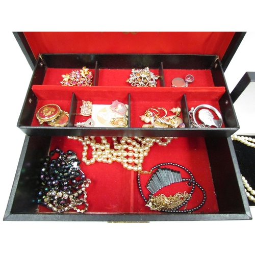 1305 - A jewellery box with bijouterie contents, necklaces, brooches and earrings