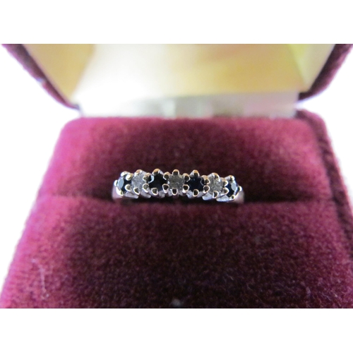 1309 - A 9ct diamond and sapphire ring