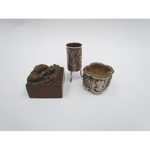 1320 - Two Chinese white metal items, a salt with exterior scenes and a miniature vase on tripod feet with ... 