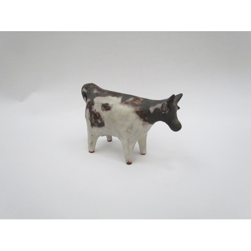 1338 - A Tessa Fuchs studio pottery figure of a cow, 8.5cm high, tail a/f