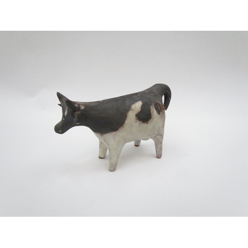 1338 - A Tessa Fuchs studio pottery figure of a cow, 8.5cm high, tail a/f