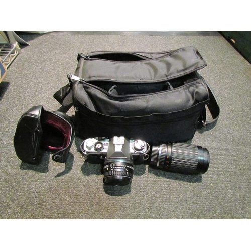 1440 - A vintage Pentax MG camera with bag and lenses