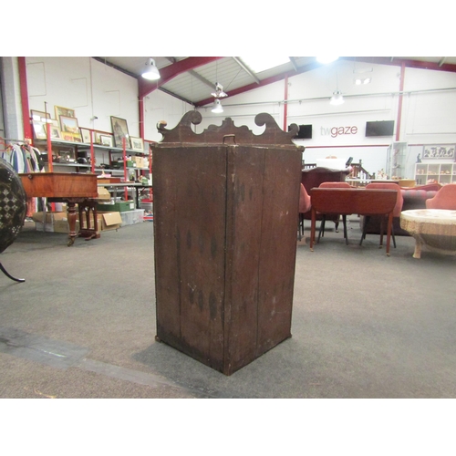 1052 - A Georgian mahogany bow fronted wall-hanging corner cabinet, scrolled crest over single door opening... 