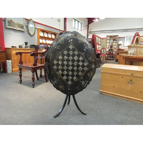 1063 - A 19th Century papier mache games table, the folding top with gilt enriched and mother-of-pearl inla... 