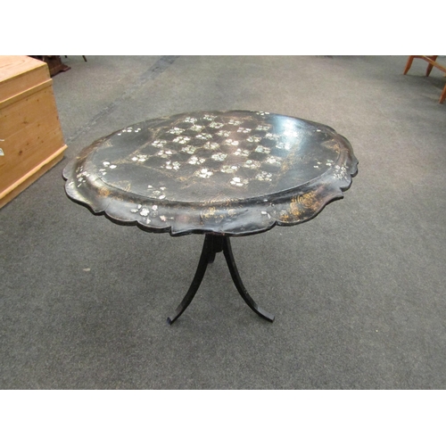 1063 - A 19th Century papier mache games table, the folding top with gilt enriched and mother-of-pearl inla... 