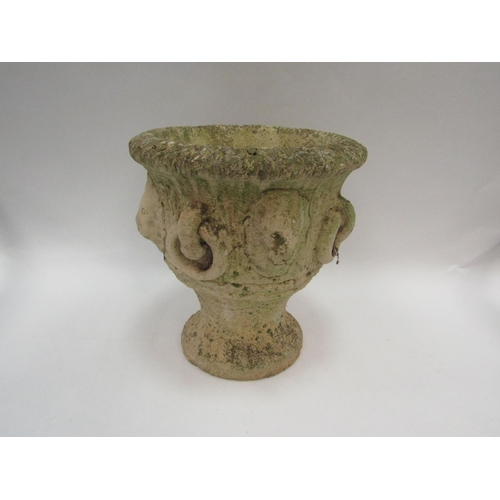 1081 - A composition garden urn with lion mask and ring loop detail to body, with Cotswold Studios Ltd. sta... 