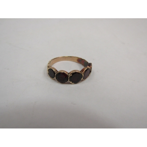 1110 - A yellow metal five stone garnet ring with textured shank, closed back, adapted with associated Aspr... 