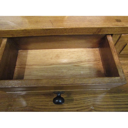 4034 - A modern oak dresser plate rack with five small drawers over three drawer three cupboard door base, ... 