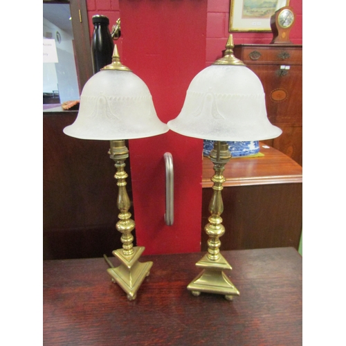 4079 - A pair of brass table lamps with triangular base on ball feet, frosted glass shades