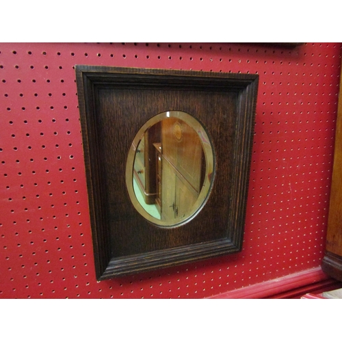 4096 - An Edwardian oak wall hanging mirror with bevel edge oval mirror, 34cm x 29cm total