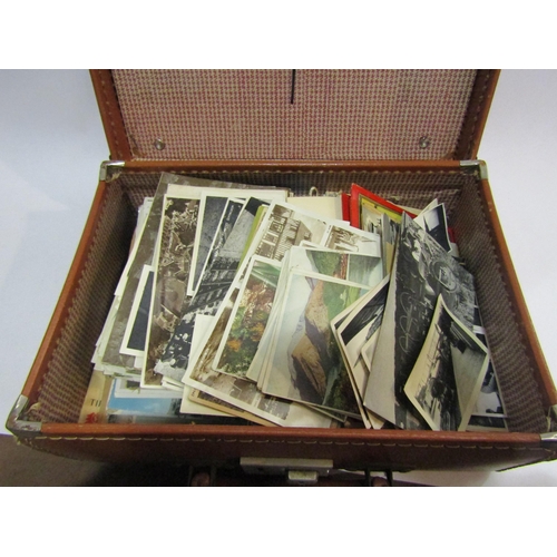 4228 - A small tan case containing black and white photographs and postcards