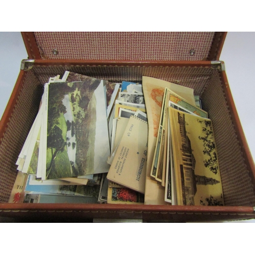 4228 - A small tan case containing black and white photographs and postcards