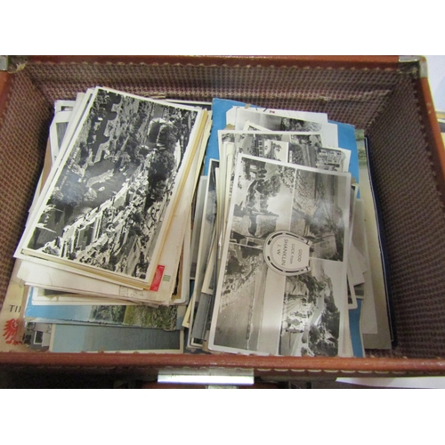 4228 - A small tan case containing black and white photographs and postcards