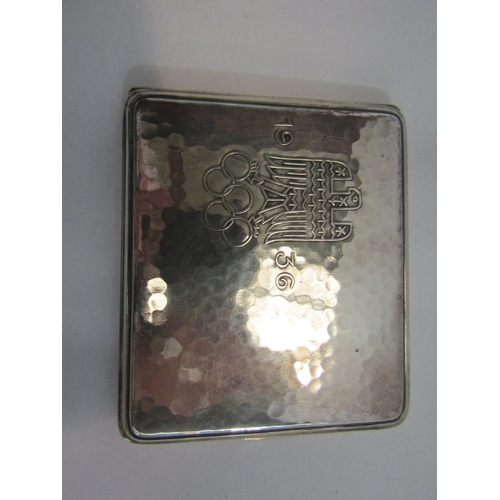 4242 - A 1936 Olympics planished metal cigarette case, a crocodile skin leather and plated hip flask by Jam... 