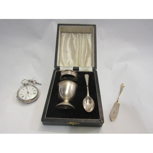 4250 - A cased silver christening set, a silver cased pocket watch and silver butter knife