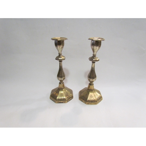 4302 - A pair of silver plated candlesticks, with scrolling foliate decoration, a/f