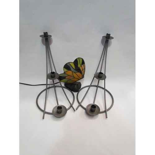 4314 - A pair of modernist metal candle holders and a stained glass butterfly lamp