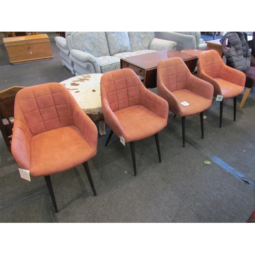 1077 - A set of four peach coloured modern tub chairs with tubular legs