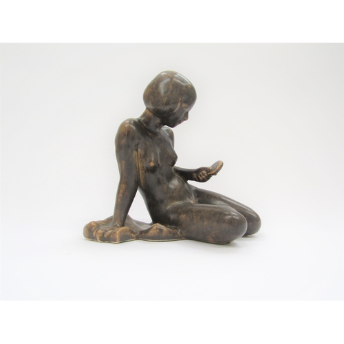 7002 - A Michael Anderson Bornholm pottery figure of a young girl, No.5979, treacle glazed, 17cm high