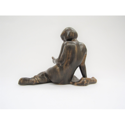 7002 - A Michael Anderson Bornholm pottery figure of a young girl, No.5979, treacle glazed, 17cm high