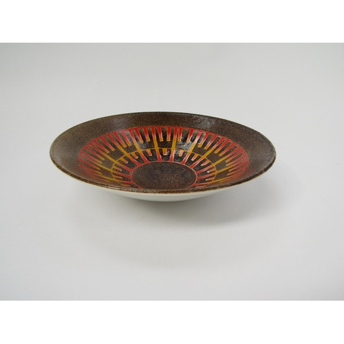 7024 - A Poole Aegean fruit bowl mottled brown with geometric orange and yellow design. Painters mark to ba... 