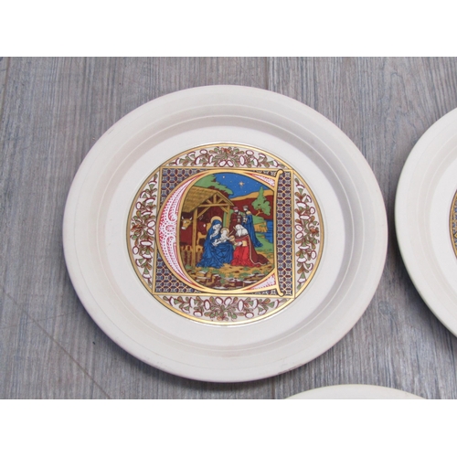 7052 - Nine Hornsea Pottery Christmas plates from the 1980's, each with printed medieval scene and letter. ... 