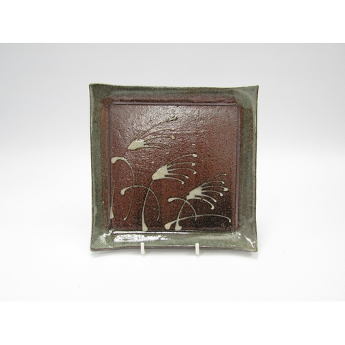 7119 - MOTOKO WAKANA (b.1962): A studio pottery square form tray with slip decoration, 18cm x 18cm