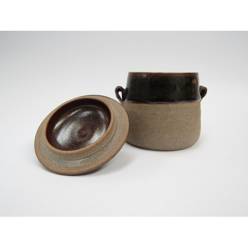 7109 - A Lowerdown Pottery lidded studio pottery pot with tenmoku glaze and a handles, impressed pottery se... 