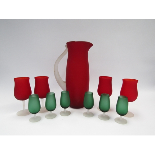 7235 - Carlo Moretti: A Murano satinato red wine ewer and four glasses, together with a set of six green Ca... 