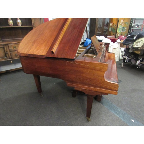 1012 - A Kent & Cooper Ltd. (Lincoln) mahogany Baby Grand piano on brass capped legs to castors