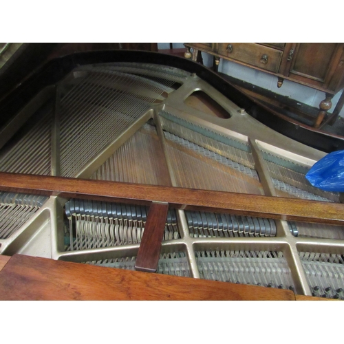 1012 - A Kent & Cooper Ltd. (Lincoln) mahogany Baby Grand piano on brass capped legs to castors