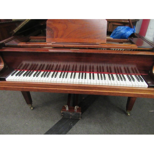 1012 - A Kent & Cooper Ltd. (Lincoln) mahogany Baby Grand piano on brass capped legs to castors