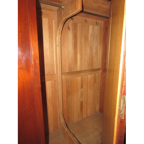 1019 - An Edwardian mahogany wardrobe with central mirrored single door over two base drawers (with key) 20... 