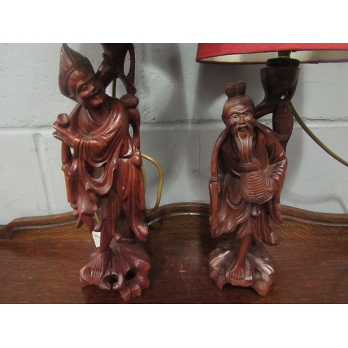 1029 - A pair of carved early 20th Century Chinese sage figural hardwood lamps    R25