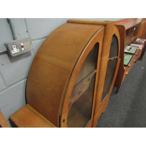 1038 - An Art Deco style walnut display cabinet, rounded form with twin glazed doors, 126cm high x 134cm wi... 