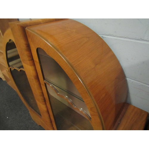 1038 - An Art Deco style walnut display cabinet, rounded form with twin glazed doors, 126cm high x 134cm wi... 