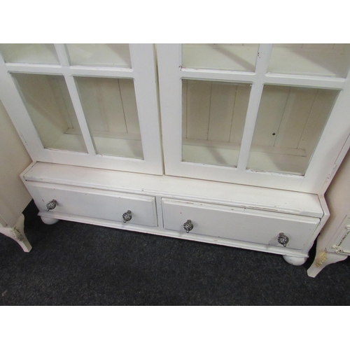 1051 - A large painted pine two door bookcase over two two base drawers on turned feet, 187cm high x 113cm ... 