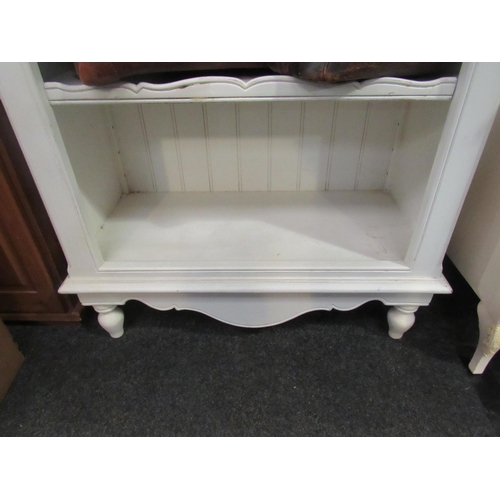 1054 - A white painted Victorian style French bookshelf on turned fore legs, 132cm high x 84cm wide x 40cm ... 