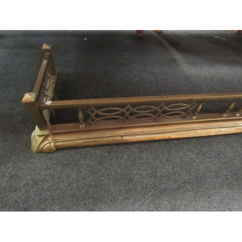 1070 - A brass pierced fire fender, 130cm long