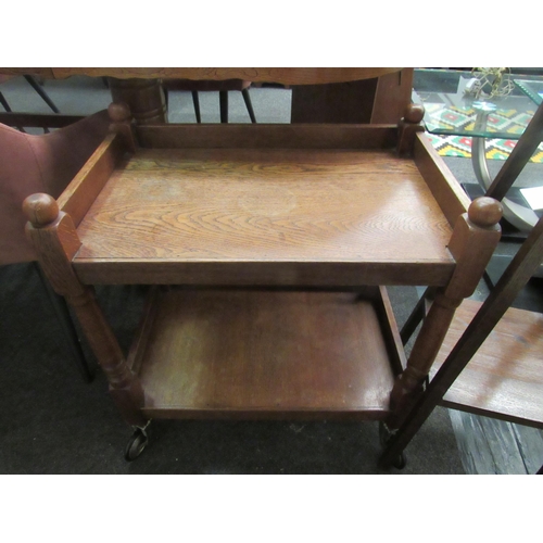 1073 - An early 20th Century oak tea trolley and a two tier oak jardiniere stand