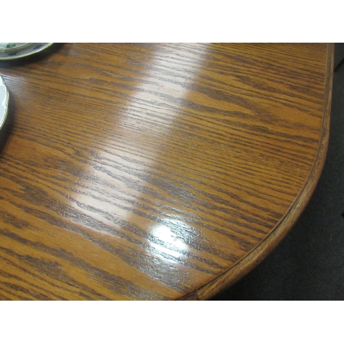 1076 - A modern oak extending dining table with two extra leaves, carved frieze with spindle base and ball ... 