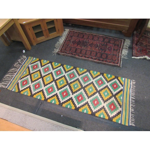 1081 - A geometric kilim rug in greens and yellows, 205cm x 76cm, together with a red ground Middle Eastern... 