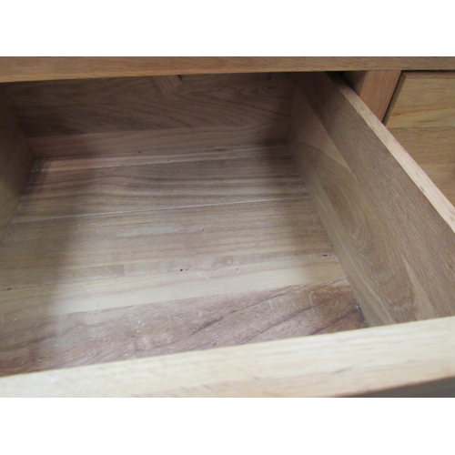 1141 - A light oak cupboard, the two drawers over twin cupboard doors, 90cm high x 90cm wide x 46cm high