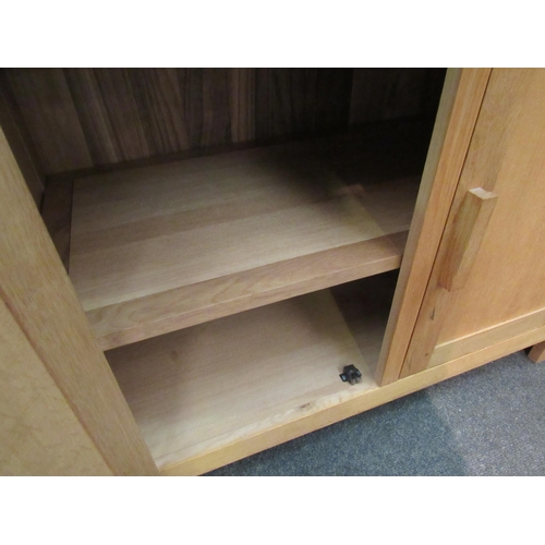 1141 - A light oak cupboard, the two drawers over twin cupboard doors, 90cm high x 90cm wide x 46cm high