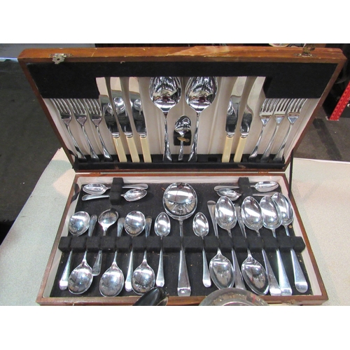 1169 - A group of white metal items including canteen of cutlery and teapot, a tablecloth etc.