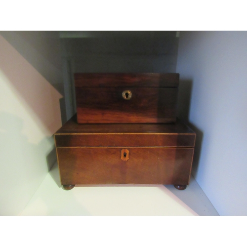 1236 - A rosewood two compartment tea caddy with key and a mahogany veneer box with stringing, on bun feet