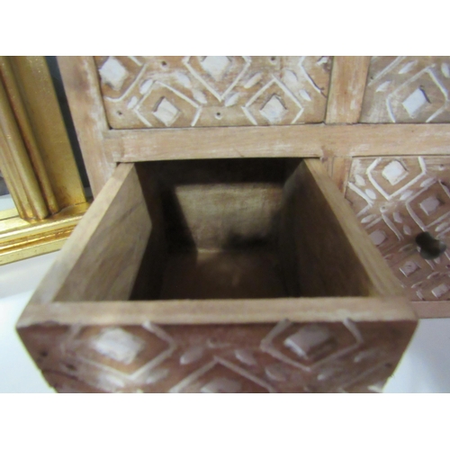 1251 - A hardwood four drawer table top cabinet, heavily carved drawer fronts, 25cm tall x 25cm wide   (R) ... 